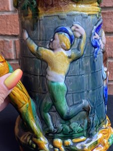 Large Minton Majolica Style Pitcher Jug With Dancing Maidens & Jesters Decoration. Circa - Vintage Reproduction Composition - Glazed Pottery/ Earthenware Beautiful Large Vibrant Glazed Pouring Jug In The Minton Majolica Style. This Design Is Typical Of Minton During The Late 19th Century. A Large Vine Like Structure Makes Up The Shaped Handle Which Entwines The Top & Bottom Edge Of The Jug With Sprays Of Grapes And Leaves. The Central Portion Of The Jug Has Large Relief Figures Of Maidens And Jesters Lavishly Posed Dancing. Very Decorative And Useable Piece. Condition- Used Vintage No Damage Lovely Condition. Dimensions In Cms Height 24.5cms Width 23cms Depth 11.5cms (top)