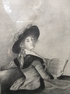 20th Century Artwork De La Barrone De Crussol Pencil And Charcoal Drawing Signed By Artist Elizabeth E Cooke and Dated 1978 Original Artwork In The Musee De Augustins Toulouse Original Artwork Dated 1785 Painted By Elizabeth Louise Vigèe Le Brun ( Famous Painter Of The Period Whom Also Painted Marie Antoinette) Pencil And Charcoal Half Portrait Drawing Of The Barrone De Crussol Florensac Whom Turns To Gaze The Viewer Over Her Shoulder. She Holds A Musical Score And Wears A Splendid Red Costume With Deep Black Velvet Collar And Matching Hat (Original In Colour) Little Is Known Of This Woman Of Great Beauty, Elegance And Distinction. Stunning Pencil And Charcoal Drawing Signed By Artist E A Cooke Set In Glazed Gilt Frame Dimensions In Inches Height 21 1/4” Width 17 1/4” Depth 1/2”
