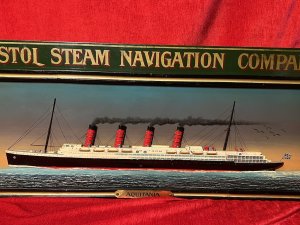 Historic Maritime Memorabilia 'HMS Aquatania' Diorama Wooden Ship Signage Circa - Vintage Composition - Wood Listing Description Large Hand Painted Decorative Ship Memorabilia Signage Plaque Of Historic Ship HMS Aquatania. Rectangular Sinage Plaque Titled 'BRISTOL STEAM NAVIGATION COMPANY' With Central Dioramic Wooden 2D Aquatania Ship Model In Full Sail, With Steam Bellowing from All Four Chimneys. Intricately Detailed Hull With Decks Visible With Windows, Lifeboats And Masts. Dated With Ships Start And End Of Service And Signed By Maker. Painted Movement Of The Sea With Central Base Brass Name Plaque Reads 'AQUATANIA'. Wall Hanging Hooks on Reverse. Lovely Historical Memorabilia Artwork For Martitime Collector/Enthusiast Display In Study, Lounge, Living Area Wall Display. A Truly Fabulous Conversation Piece. Dimensions In Inches Height 16.5" X Width 45"