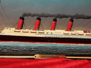 Historic Maritime Memorabilia 'HMS Aquatania' Diorama Wooden Ship Signage Circa - Vintage Composition - Wood Listing Description Large Hand Painted Decorative Ship Memorabilia Signage Plaque Of Historic Ship HMS Aquatania. Rectangular Sinage Plaque Titled 'BRISTOL STEAM NAVIGATION COMPANY' With Central Dioramic Wooden 2D Aquatania Ship Model In Full Sail, With Steam Bellowing from All Four Chimneys. Intricately Detailed Hull With Decks Visible With Windows, Lifeboats And Masts. Dated With Ships Start And End Of Service And Signed By Maker. Painted Movement Of The Sea With Central Base Brass Name Plaque Reads 'AQUATANIA'. Wall Hanging Hooks on Reverse. Lovely Historical Memorabilia Artwork For Martitime Collector/Enthusiast Display In Study, Lounge, Living Area Wall Display. A Truly Fabulous Conversation Piece. Dimensions In Inches Height 16.5" X Width 45"