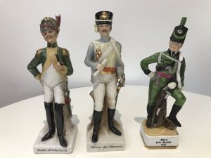 3 Porcelain French Cavelry Officer Figurines Named Figurines 1. Soldat d’Infanteria 2. Officer Rifle Brigade 1815 3. Officer des chasseurs Handmade In French Factory Dated 1930’s Dimensions In Inches 1 H 8.5” W 2.5” 2 H 8.1/4” W 2.1/4” 3 H 8.3/4” W 2.5”