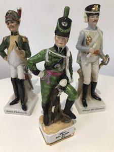 3 Porcelain French Cavelry Officer Figurines Named Figurines 1. Soldat d’Infanteria 2. Officer Rifle Brigade 1815 3. Officer des chasseurs Handmade In French Factory Dated 1930’s Dimensions In Inches 1 H 8.5” W 2.5” 2 H 8.1/4” W 2.1/4” 3 H 8.3/4” W 2.5”