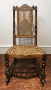Aesthetic Movement Rare Cane Serpentine Front Spindle Back Rocking Chair Solid Wood Frame Made In Red Walnut Interesting Arched Back With Turned Stretchers And Engine Turned Legs Came Back And Seat Quality Chair With Sturdy Frame Showing Signs Of Wear Especially On The Rockers Conductive To Age And Usage Rare Piece And Original Antique Item Dimensions In Inches Height 35” Seat Height 14” Width 18” Depth 24”