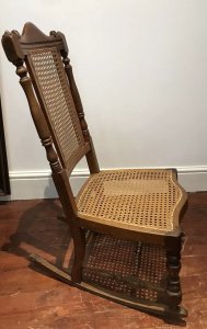 Aesthetic Movement Rare Cane Serpentine Front Spindle Back Rocking Chair Solid Wood Frame Made In Red Walnut Interesting Arched Back With Turned Stretchers And Engine Turned Legs Came Back And Seat Quality Chair With Sturdy Frame Showing Signs Of Wear Especially On The Rockers Conductive To Age And Usage Rare Piece And Original Antique Item Dimensions In Inches Height 35” Seat Height 14” Width 18” Depth 24”