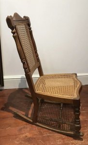 Aesthetic Movement Rare Cane Serpentine Front Spindle Back Rocking Chair Solid Wood Frame Made In Red Walnut Interesting Arched Back With Turned Stretchers And Engine Turned Legs Came Back And Seat Quality Chair With Sturdy Frame Showing Signs Of Wear Especially On The Rockers Conductive To Age And Usage Rare Piece And Original Antique Item Dimensions In Inches Height 35” Seat Height 14” Width 18” Depth 24”