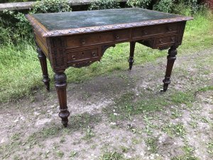 Fine Victorian Carved Writing Desk By Nelson London 1875 Cabinet Maker To Nobility Base Of Drawer Signed 3 Dovetail Drawers With Shaped And Carved Kneehole Original Green Well Weathered Leather Top Worn With Age And Usage Oak Desk Profoundly Carved All Around Stunning Carved Rose Handles Carved Acanthus Leaves On Turned Legs With Brass Wheel Feet Top Quality Hand Made Piece Provenance From Andross Castle Perthshire And Stored For Many Years In Surrey England Elegant Rare Desk Dimensions In Inches Height 31” Width 48” Depth 30”
