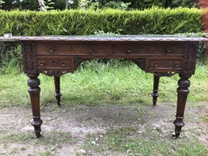 Fine Victorian Carved Writing Desk By Nelson London 1875 Cabinet Maker To Nobility Base Of Drawer Signed 3 Dovetail Drawers With Shaped And Carved Kneehole Original Green Well Weathered Leather Top Worn With Age And Usage Oak Desk Profoundly Carved All Around Stunning Carved Rose Handles Carved Acanthus Leaves On Turned Legs With Brass Wheel Feet Top Quality Hand Made Piece Provenance From Andross Castle Perthshire And Stored For Many Years In Surrey England Elegant Rare Desk Dimensions In Inches Height 31” Width 48” Depth 30”