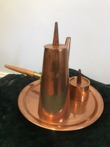 Vintage Arts And Crafts Conical Shaped Copper 4 Pcs Coffee Set By ARGY Europe 4 Piece Set Includes Conical Shaped Coffee Pot, Cream Jug And Lidded Sugar Basin With Teak Handles Sitting On Copper Circular Tray Unique Stylish Design Composition - Copper Outer With Tin Lining Condition- Used Good Circa - 1930’s Signs Of Wear Small Dents And Scratches Dow To Age And Usage Dimensions In Inches Tray Diameter 10.5” Coffee pot height 9.5” Width 3.5” Sugar Basin Height 4” Width 2 3/4” Cream Jug Height 2.5” Width 2.5”