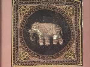 Beautiful Indian Applique Tapestry Of Elephant In Bleaches Oak Box Frame. Hand Woven Silks And Hessian Thread Tapestry Of A Centralised Elephant In Black Circular Boarder With Contrasting Decorative Boarders Surrounding In Delicate Glass Bread Work, Sequins And Decorative Embroidery Stitch Work. Set In Fine Bleached Oak Frame. Beautiful Hand Woven Tapestry And Appliqué Work. Elephants In Hinduism And The Indian Culture A re Simnolic Of Intellectual And Earthly Mental Strength.It Is A Sacred Animal And Is Considered The Representation Or Living Incarnation Of Ganesha, The Elephant Headed Deity Rising A Mouse. Originally From Calcutta. Collectors Piece Dimensions In Inches Height Width Depth
