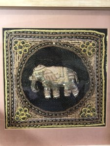 Beautiful Indian Applique Tapestry Of Elephant In Bleaches Oak Box Frame. Hand Woven Silks And Hessian Thread Tapestry Of A Centralised Elephant In Black Circular Boarder With Contrasting Decorative Boarders Surrounding In Delicate Glass Bread Work, Sequins And Decorative Embroidery Stitch Work. Set In Fine Bleached Oak Frame. Beautiful Hand Woven Tapestry And Appliqué Work. Elephants In Hinduism And The Indian Culture A re Simnolic Of Intellectual And Earthly Mental Strength.It Is A Sacred Animal And Is Considered The Representation Or Living Incarnation Of Ganesha, The Elephant Headed Deity Rising A Mouse. Originally From Calcutta. Collectors Piece Dimensions In Inches Height Width Depth