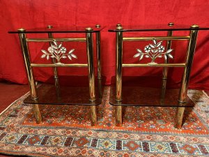 Pair Of Italian Designer Brass Maritime Side Tables With Pearl Inlaid Bouquets. Circa - 1980 Composition - Polished Brass With Smoked Glass Listing Description Pair Of Impressive Italian Designer Polished Brass Maritime Side/Occasional Tables. Square Shape With Smoke Glass Tops And Under Shelves For Storage & Ornament Display. Showcasing Elaborate Front Facing Mother Of Pearl Inlaid Motif Bouquets And Set Upon Four Cylindrical Column Legs. Condition- Excellent Used Minor Scratches Visible to Glass Surface Due To Age And Usage. Dimensions In Inches Height 22” Width 18” SQ