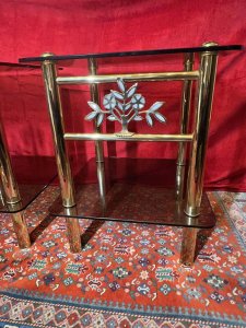 Pair Of Italian Designer Brass Maritime Side Tables With Pearl Inlaid Bouquets. Circa - 1980 Composition - Polished Brass With Smoked Glass Listing Description Pair Of Impressive Italian Designer Polished Brass Maritime Side/Occasional Tables. Square Shape With Smoke Glass Tops And Under Shelves For Storage & Ornament Display. Showcasing Elaborate Front Facing Mother Of Pearl Inlaid Motif Bouquets And Set Upon Four Cylindrical Column Legs. Condition- Excellent Used Minor Scratches Visible to Glass Surface Due To Age And Usage. Dimensions In Inches Height 22” Width 18” SQ