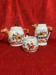 Gentlemen's British Hunt Scene Portland Pottey Tea Service Circa - 1940 Composition - Ceramic Listing Description British Fox Hunting Gentlesman's Tea Service. Complete With Tea Pot , Cream Jug And Sugar Bowl. Both Teapot And Jug With Fox Head Spouts. All Pieces Complete With Red Coat Hunt Master On Horse Back With Red Foxes On Front Elevations With Wreath And Decorative Hunt Design On Reverse. Condition - V Good Signs Of Wear To Glaze. Dimensions in Cms Teapot Cream Jug Sugar bowl