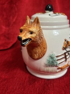 Gentlemen's British Hunt Scene Portland Pottey Tea Service Circa - 1940 Composition - Ceramic Listing Description British Fox Hunting Gentlesman's Tea Service. Complete With Tea Pot , Cream Jug And Sugar Bowl. Both Teapot And Jug With Fox Head Spouts. All Pieces Complete With Red Coat Hunt Master On Horse Back With Red Foxes On Front Elevations With Wreath And Decorative Hunt Design On Reverse. Condition - V Good Signs Of Wear To Glaze. Dimensions in Cms Teapot Cream Jug Sugar bowl