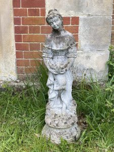 Andromeda Grecian Goddess Holding Turtle Dove Vintage Garden Sculpture. Circa - Vintage Composition- Reconstituted Stone Stunning Grecian Beauty Dressed In Elaborate Off The Shoulder Tiered Gown Holding Turtle Dove. Detailed Gown With Frills, Ribbons And Bows. Goddess With Delicate Facial Features Standing Upon Circular Plinth Base Decorated With Roses. Provenance Purchased From Port Elliot, Lisgaurd Cornwall. Dimensions In Cms Height 83cm Width 27cm Depth 27cm