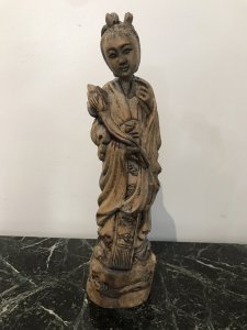Two Oriental Fruitwood Carvings One Female With Fine Carved Robe Details Holding Flowers One Large Male Carving With Unusual Long Carved Hair And Flowing Robe Origin Unknown Presumed To Be Chinese Collectors Items Dimensions In Inches Male Height 15” Width 4” Female Height 12” Width 3.5”