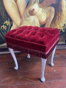 Vintage Hollywood Glamour Red Velvet Deep Buttoned Boudoir Stool. Circa - Vintage Composition - Red velvet Upholstery& Hard Wood Frame Beautiful Red Velvet Deep Buttoned Upholstered Stool With Carved Hardwood Legs Overpainted In White. Finished In Red Fringe. Deep Piled Seat Is Sumptuously Comfortable. Vintage Original Condition. Lovely Hollywood Glamour Piece Perfect For Ladies Boudoir. Condition- Stunning Used Vintage Two Buttons Missing Due To Age And Usage. Dimensions In Inches Height 19.5” Width 18” Depth 14.5”
