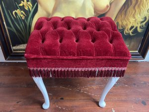 Vintage Hollywood Glamour Red Velvet Deep Buttoned Boudoir Stool. Circa - Vintage Composition - Red velvet Upholstery& Hard Wood Frame Beautiful Red Velvet Deep Buttoned Upholstered Stool With Carved Hardwood Legs Overpainted In White. Finished In Red Fringe. Deep Piled Seat Is Sumptuously Comfortable. Vintage Original Condition. Lovely Hollywood Glamour Piece Perfect For Ladies Boudoir. Condition- Stunning Used Vintage Two Buttons Missing Due To Age And Usage. Dimensions In Inches Height 19.5” Width 18” Depth 14.5”