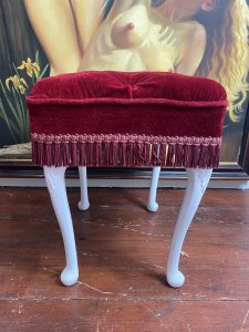 Vintage Hollywood Glamour Red Velvet Deep Buttoned Boudoir Stool. Circa - Vintage Composition - Red velvet Upholstery& Hard Wood Frame Beautiful Red Velvet Deep Buttoned Upholstered Stool With Carved Hardwood Legs Overpainted In White. Finished In Red Fringe. Deep Piled Seat Is Sumptuously Comfortable. Vintage Original Condition. Lovely Hollywood Glamour Piece Perfect For Ladies Boudoir. Condition- Stunning Used Vintage Two Buttons Missing Due To Age And Usage. Dimensions In Inches Height 19.5” Width 18” Depth 14.5”
