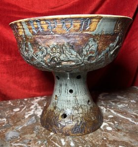 Large Cornish Studio Pottery 'Good Cheer Upon This House' Fruit Bowl Circa - 1970 Composition - Earthenware Listing Description Large Ornamental Studio Pottery Fruit Bowl On Stand. Top Bowl For Holding Fruit Or Decorative Items, Shaped Like A Spherical Cap And Set Upon Tapered Base With Circular Vent Holes. Wonderful Hand Etched Pattern Of Oak Leaves With Entwined Majestical Flowers, With The Top Edge Of The Bowl Reading 'Good Cheer Upon This House' In Scripture Style Text. Fruit Bowl Finished With Rich Kiln Sage Green And Brown Glaze. A Interesting And Very Useful Piece In Pristine Condition. Dimensions in Inches Height 11" X Top Diam 12" For Further Information Please Call The Curator On 07707 488 566 Thank-you.