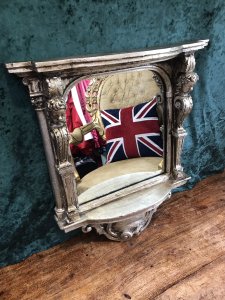 Italian Reproduction Silver Serpentine Shaped Cherub Pier Glass Mirror Ornate Pillars Adorned With Cherubs Heads Bow Fronted Top With Ornate Scrollwork Stunning Shaped Ornate Base Made In Resin Very Heavy Item 22Kg Approx Brackets At The Back For Hanging Dimensions In Inches Height 22” Width 20” Depth 5.5”