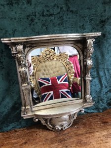 Italian Reproduction Silver Serpentine Shaped Cherub Pier Glass Mirror Ornate Pillars Adorned With Cherubs Heads Bow Fronted Top With Ornate Scrollwork Stunning Shaped Ornate Base Made In Resin Very Heavy Item 22Kg Approx Brackets At The Back For Hanging Dimensions In Inches Height 22” Width 20” Depth 5.5”