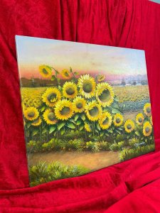 American 20th Century Artist Charles Redmond Bernolt Impasto Oil Painting Titled Field Of Sunflowers Circa - 20th Century Composition - Oil On Canvas Vibrant Sunflower Filled Landscape Painting. The Front Row Of Large Sunflowers In Thick Impasto Paint Effect With Three Dimensional Textural Appearance. In The Distance A Field Filled With Thousands Of Sunflowers. Fabulous Perspective Showcasing Rich Pink Sunset Over The Sea And Mountainous Backdrop. Amazing Detail By Accomplished Artist Charles Redmond Bernolt Signed Right Bottom Corner. Unframed. Dimensions In Inches Height 20" X Width 23 3/4" For Further Information Please Call The Museum Curator On 07707 488566 Thank-you
