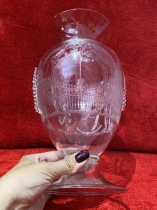 French Antique 19th Century Palace Of Versailles Etched Glass Decorative Vase. Circa - 1850 Origin - France Fine Quality Beautifully Detailed And Hand Crafted Etched Glass Vase With Overlaid Glass Ornamentation. Bouquet Shaped Vase With Round Glass Plinth Base Pediment. The Front Depicting The Palace Of Versailles Grand Entrance Gates With Column Pillars Adorned With Putti. On The Reverse Male And Female Believed To Be Marie Antoinette & Louis XVI Posed Figures In Traditional 18th Century Clothing In Stunning Tree Veranda Scene. Hand Blown Pontil Mark On The Base. Finely Engraved But Craftsman Unknown No Makers Mark. Dimensions In Inches Height 9 1/2” Width 5 1/4” Neck Diam 4.5” Base Diam 4.5”