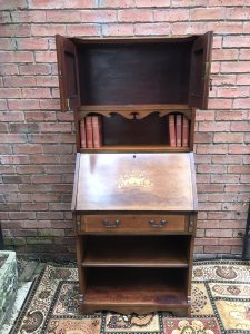 Fine Red Walnut Arts And Crafts Secretaire Bookcase Shaped Top Pediment With Double Doors For Book Storage Drop Down Front With Pull Out Supports Displaying Stunning Satinwood And Pewter Inlays Of Musical Instruments And Foliage Shelves Under Pull Out Drawer Red Walnut Cabinet With With Oak Lined Drawer Delightful Item In Beautiful Condition With Original Key Dimensions In Inches Height 65” Width 28” Depth 15”