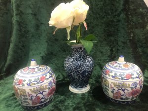 Pair Of Reproduction Kang Sing Style Porcelain Lidded Ginger Jars Composition- Porcelain Circa- Vintage Reproduction Pair Lidded Bulbas Ginger Jars With Domed Top And Delicate Handle Richly Decorated With Native Chinese Lotus Flowers And Chinese Blossoms White Glaze Jars With Rich Blue, Pink, Red, Yellow And Green Hues Chinese Markings On The Bases Lovely Examples Of Sought After Chinese Vases Dimensions In Inches Height 5.5” Width 5” Circumference 15” Widest Point