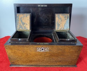 William IIII Rosewood Sarcophagus Shaped Tea Caddy With Mother Of Pearl Inlay Beautiful Solid Rosewood Tea Caddy Chest With Egg And Dart Gadrooned Top Edge With Mother Of Pearl Inlay Floral Motifs On The Top Lid ( Monogramed R.H.B) And Around Lock. Each Side Bears Drop Ring Handles. (One Missing) Inside The Chest There Are Two Hinged Top Compartments For Tea And A Circular Slot For Mixing Bowl Or Drinking Flask. Stunning Rich Patina Antique Tea Chest. Dimensions In Inches Height 8” Width 13” Depth 6”