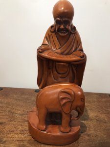 Asian Carved Fruitwood Buddha Statue Reading A Scroll With Elephant At His Feet Well Carved Solid Wood Lovely Patina And Interesting Subject Dimensions In Inches Height 13” Base Width 4.5”