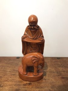 Asian Carved Fruitwood Buddha Statue Reading A Scroll With Elephant At His Feet Well Carved Solid Wood Lovely Patina And Interesting Subject Dimensions In Inches Height 13” Base Width 4.5”