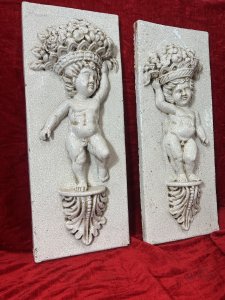 Fine Pair Of Marblesque Cherub Plaques With Cracked Glazed Marble Patina Large Pair Of Cherub Plaques, Both Posed Standing Upon Acanthus Leaf Plinth, With Opposite Hands Holding Large Fruit And Floral Bouquet Crowns. Condition - Very Good Antiqued Item, Minor Blemishes And Cracking Visible. Dimensions In Inches Height 27.5" X Width 10 3/4" X Depth 5" For Further Information Please Call Our Museum Curator On 07707 488566 Thank-you.