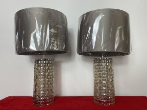 Pair Modern Art Contemporary Geometric Glass Lamps With Shades. Circa - Modern Reproduction Composition - Glass Condition - Used Pristine Matching Pair Of Modernistic Designer Glass Table Top Lamps, Both Cylindrical Bases In A Geometric Pattern With Holographic Finish In Champagne Colour. Singular Bulb Fixtures With British Corded Plug With On/Off Switch. Complete With Beige Gold Shade. Unused/ Unboxed Dimensions In Inches Height With Shades 19" Base Height Including Bulb Mount 15.5" Base Diameter 4 1/4"