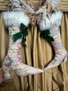 Pair Of Designer Opulent Christmas Stocking Boots. Bespoke designer stocking boots in dusky pink/ Green And Beige regency silk brocade. Faux lace up fronts in satin ribbon with large green bow. Fully lined in gold satin with matching fabric hanging loops. Quality white Speckled Faux fur Trim. Hand drawn pattern One Of A kind. Stunning edition to opulent Christmas decor. Buy them before they are gone won’t be on sale for long Dimensions Height 23” Width 15” heel to toe Top opening width 11” Hanging Loop 3” #christmas stockings #glamourstockingboots #Cheistmasdecor