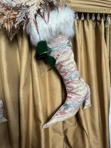 Pair Of Designer Opulent Christmas Stocking Boots. Bespoke designer stocking boots in dusky pink/ Green And Beige regency silk brocade. Faux lace up fronts in satin ribbon with large green bow. Fully lined in gold satin with matching fabric hanging loops. Quality white Speckled Faux fur Trim. Hand drawn pattern One Of A kind. Stunning edition to opulent Christmas decor. Buy them before they are gone won’t be on sale for long Dimensions Height 23” Width 15” heel to toe Top opening width 11” Hanging Loop 3” #christmas stockings #glamourstockingboots #Cheistmasdecor