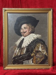 The Laughing Cavalier Wool-work Tapestry After Frans Hals 1624 Circa - Vintage Composition - Wool Weave/ Glazed Gilt Frame Listing Description Finely Hand Woven Wool Work Tapestry Composition Of Known Portrait Titled 'The Laughing Cavelier' By Dutch Golden Age Painter Frans Hals Dated 1624. The Original Painted Portrait Is Housed At The Prestigious Wallace Collection In London. The Cavalier In Deep Earthy Toned Colour Palette With Vivid Patterned Tunic, Large White Neck Ruff And Typical Wide Brimmed Hat. Facial Features In Fine Details. Charming Piece Set In Glazed Ornate Gilt Frame. Dimensions In Inches Height 19.5" x width 16" For Further Information Please Call The Museum Curator On 07707 488566 Thankyou.