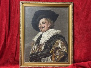 The Laughing Cavalier Wool-work Tapestry After Frans Hals 1624 Circa - Vintage Composition - Wool Weave/ Glazed Gilt Frame Listing Description Finely Hand Woven Wool Work Tapestry Composition Of Known Portrait Titled 'The Laughing Cavelier' By Dutch Golden Age Painter Frans Hals Dated 1624. The Original Painted Portrait Is Housed At The Prestigious Wallace Collection In London. The Cavalier In Deep Earthy Toned Colour Palette With Vivid Patterned Tunic, Large White Neck Ruff And Typical Wide Brimmed Hat. Facial Features In Fine Details. Charming Piece Set In Glazed Ornate Gilt Frame. Dimensions In Inches Height 19.5" x width 16" For Further Information Please Call The Museum Curator On 07707 488566 Thankyou.