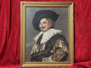 The Laughing Cavalier Wool-work Tapestry After Frans Hals 1624 Circa - Vintage Composition - Wool Weave/ Glazed Gilt Frame Listing Description Finely Hand Woven Wool Work Tapestry Composition Of Known Portrait Titled 'The Laughing Cavelier' By Dutch Golden Age Painter Frans Hals Dated 1624. The Original Painted Portrait Is Housed At The Prestigious Wallace Collection In London. The Cavalier In Deep Earthy Toned Colour Palette With Vivid Patterned Tunic, Large White Neck Ruff And Typical Wide Brimmed Hat. Facial Features In Fine Details. Charming Piece Set In Glazed Ornate Gilt Frame. Dimensions In Inches Height 19.5" x width 16" For Further Information Please Call The Museum Curator On 07707 488566 Thankyou.