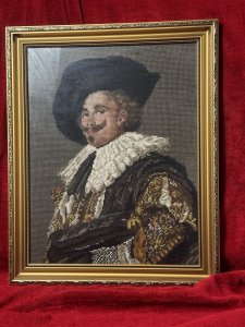 The Laughing Cavalier Wool-work Tapestry After Frans Hals 1624 Circa - Vintage Composition - Wool Weave/ Glazed Gilt Frame Listing Description Finely Hand Woven Wool Work Tapestry Composition Of Known Portrait Titled 'The Laughing Cavelier' By Dutch Golden Age Painter Frans Hals Dated 1624. The Original Painted Portrait Is Housed At The Prestigious Wallace Collection In London. The Cavalier In Deep Earthy Toned Colour Palette With Vivid Patterned Tunic, Large White Neck Ruff And Typical Wide Brimmed Hat. Facial Features In Fine Details. Charming Piece Set In Glazed Ornate Gilt Frame. Dimensions In Inches Height 19.5" x width 16" For Further Information Please Call The Museum Curator On 07707 488566 Thankyou.