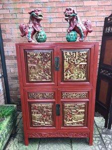 Rare Imperial Red Lacquer & Gilt Marriage Cabinet With Hand Carved Panels Hand Carved Gilt Panels On The Front Doors Depicting Battle Scenes With Extraordinary Horses, Warriors, Fruit & Foliage. 4 Opening Doors With Shaped Metal Handels With Two Drawers And Shelving Inside. Craftsman Seal Signed On The Front Panel With Fielded Side Panels Stands Upon 4 Sturdy Legs Museum Piece Exceptional Quality Cabinet Composition- Carved Fruitwood With Red Lacquer And Gilt Work Overall Condition- Very Good Provenance Part Of Oriental Private Collection At The Lord Hill Museum Please Note This Is A Antique Piece And May Have Blemishes And Signs Of Use And Wear Due To Age Dimensions In Inches Height 55” Width 37” Depth 15.5”