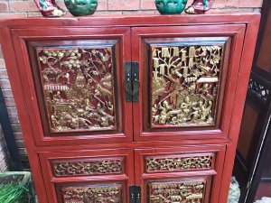 Rare Imperial Red Lacquer & Gilt Marriage Cabinet With Hand Carved Panels Hand Carved Gilt Panels On The Front Doors Depicting Battle Scenes With Extraordinary Horses, Warriors, Fruit & Foliage. 4 Opening Doors With Shaped Metal Handels With Two Drawers And Shelving Inside. Craftsman Seal Signed On The Front Panel With Fielded Side Panels Stands Upon 4 Sturdy Legs Museum Piece Exceptional Quality Cabinet Composition- Carved Fruitwood With Red Lacquer And Gilt Work Overall Condition- Very Good Provenance Part Of Oriental Private Collection At The Lord Hill Museum Please Note This Is A Antique Piece And May Have Blemishes And Signs Of Use And Wear Due To Age Dimensions In Inches Height 55” Width 37” Depth 15.5”