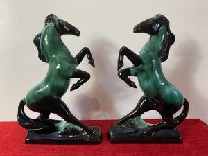 Pair Of Art Deco Style Terracotta Teal Drip Glazed Rearing Stallion Figurines Circa - 1960's Composition - Terracotta Shell With Kiln Fired Drip Glaze Listing Description Fine Pair Of Decorative Rearing Stallions In A Rich Black High Shine Lacquer, With Marble Teal Drip Over Glaze. Posed Arched Fetlocks, Sweeping Main And Long Tail Leading Into Rectangular Bases. Stunning Quality Pair of Horse Figurines With A Strong Art Deco Influence. A Beautiful Feminine Decorative Pair Of Figurines For Mantle , Cabinet Or Wall Display. Dimensions in Inches Height 14" Width 9.5" Depth 3"
