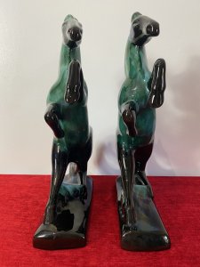 Pair Of Art Deco Style Terracotta Teal Drip Glazed Rearing Stallion Figurines Circa - 1960's Composition - Terracotta Shell With Kiln Fired Drip Glaze Listing Description Fine Pair Of Decorative Rearing Stallions In A Rich Black High Shine Lacquer, With Marble Teal Drip Over Glaze. Posed Arched Fetlocks, Sweeping Main And Long Tail Leading Into Rectangular Bases. Stunning Quality Pair of Horse Figurines With A Strong Art Deco Influence. A Beautiful Feminine Decorative Pair Of Figurines For Mantle , Cabinet Or Wall Display. Dimensions in Inches Height 14" Width 9.5" Depth 3"