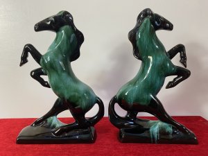 Pair Of Art Deco Style Terracotta Teal Drip Glazed Rearing Stallion Figurines Circa - 1960's Composition - Terracotta Shell With Kiln Fired Drip Glaze Listing Description Fine Pair Of Decorative Rearing Stallions In A Rich Black High Shine Lacquer, With Marble Teal Drip Over Glaze. Posed Arched Fetlocks, Sweeping Main And Long Tail Leading Into Rectangular Bases. Stunning Quality Pair of Horse Figurines With A Strong Art Deco Influence. A Beautiful Feminine Decorative Pair Of Figurines For Mantle , Cabinet Or Wall Display. Dimensions in Inches Height 14" Width 9.5" Depth 3"