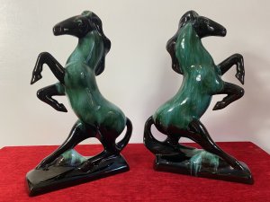Pair Of Art Deco Style Terracotta Teal Drip Glazed Rearing Stallion Figurines Circa - 1960's Composition - Terracotta Shell With Kiln Fired Drip Glaze Listing Description Fine Pair Of Decorative Rearing Stallions In A Rich Black High Shine Lacquer, With Marble Teal Drip Over Glaze. Posed Arched Fetlocks, Sweeping Main And Long Tail Leading Into Rectangular Bases. Stunning Quality Pair of Horse Figurines With A Strong Art Deco Influence. A Beautiful Feminine Decorative Pair Of Figurines For Mantle , Cabinet Or Wall Display. Dimensions in Inches Height 14" Width 9.5" Depth 3"