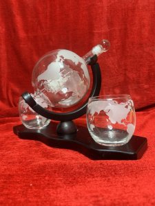 Whisky Globe Decanter Set By The Wine Savant Co Circa - Vintage Composition - Glass/ Wood Display Base Listing Description Globe Shaped Revolving Glass Decanter Bottle, Revealing Interior Hand Crafted 'Masted Ship In A Bottle' With Exterior World Map Etching. Complete Set With Two Whisky Tumblers Also With World Map Etching. Set Upon Mahogany Stained Plinth Base. Wonderful Showpiece For Whisky Enthusiast. Library/ Gentleman's Room/ Dining Room Showpiece. Great Talking Point And Wonderful Useful Gift Idea. Pristine condition. Dimensions In Cms Whisky Globe Height 24cm X Width33cm Base X Depth 14cm Glasses Height 8.5cm X 7.5cm Circum