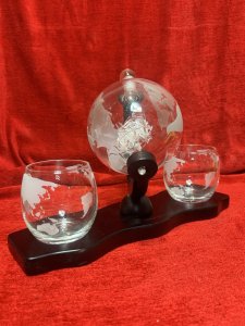 Whisky Globe Decanter Set By The Wine Savant Co Circa - Vintage Composition - Glass/ Wood Display Base Listing Description Globe Shaped Revolving Glass Decanter Bottle, Revealing Interior Hand Crafted 'Masted Ship In A Bottle' With Exterior World Map Etching. Complete Set With Two Whisky Tumblers Also With World Map Etching. Set Upon Mahogany Stained Plinth Base. Wonderful Showpiece For Whisky Enthusiast. Library/ Gentleman's Room/ Dining Room Showpiece. Great Talking Point And Wonderful Useful Gift Idea. Pristine condition. Dimensions In Cms Whisky Globe Height 24cm X Width33cm Base X Depth 14cm Glasses Height 8.5cm X 7.5cm Circum
