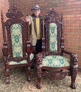 Fine Reproduction Pair Of Colonial Throne Seats With Lion Claw Feet. Circa - Vintage Reproduction Composition- Hardwood Exceptional Pair Of Profusely Carved High Back Throne Chairs. Towering High Backs With Central Coat Of Arms Plaque With Double Pinnacles Leading Down Into Lion Head Armrests. The Decorative Back Rests Hand Carved With Scrolled Acanthus Leaves & Entwined Coats Of Arms With Central Cushioned Panel Finished With Brass Stud Design. A Lovely Wide Seat Upholstered With Rich Green/Gold Silk Decorated With Bouquets Of Flowers, Swags And Tassels. Standing Upon Elaborate Lion Claw Feet With Rose Motifs. Stunning Hand Carved Craftsman Made Hardwood Chairs Finished In French Polished Patina. Original Condition A Museum Quality Pair. Fabulous Pair For Prestigious Collector/ Interior Designer /Film Production Prop. Would Look Amazing Next To Large Fireplace Or In Elaborate Entrance Hall / Lounge Area. Provenance Purchased From Prestigious Castle In The Scottish Highlands. Dimensions In Cms Back Height 185cm Width 90cm Seat Width 52cm Front To Back Depth 73cm